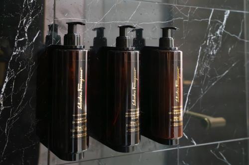 three black bottles are hanging on a wall at Iris Hotel Boston in Brookline