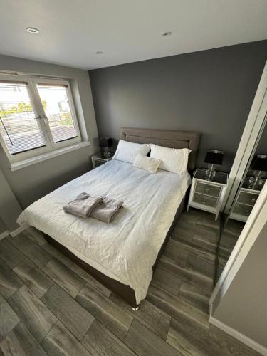 a bedroom with a bed with two towels on it at KM Granton Apartment in Edinburgh