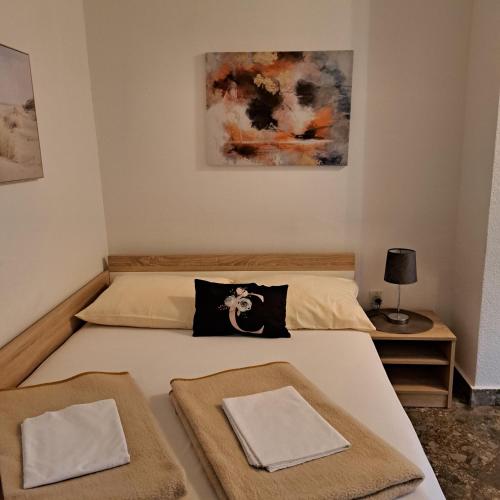 a bedroom with a bed with two towels on it at Apartment Sara M in Gajac