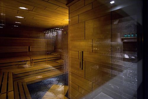 a sauna with wooden walls and benches in a room at Sofitel Munich Bayerpost in Munich