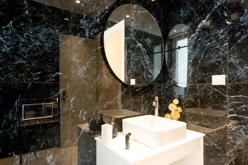 a bathroom with a sink and a mirror at Villa Vilielmini Paxos in Gaios