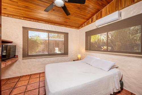 a bedroom with a bed and a ceiling fan at BP Surf Hotel in Playa Grande