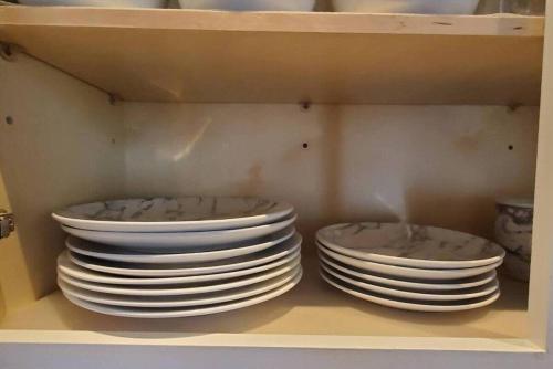 two stacks of plates sitting on a shelf at Spacious&Gracious- 5BR Fam-Friendly near I95&Shops in Fairfield