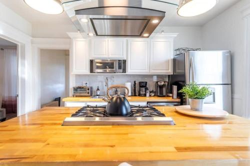 a kitchen with a stove with a tea kettle on it at Spacious&Gracious- 5BR Fam-Friendly near I95&Shops in Fairfield