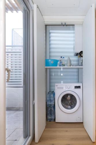 a washer and dryer in a kitchen with a window at Sunshine Suite in Senigallia
