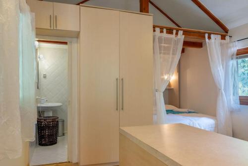a bathroom with a white cabinet and a bedroom at Pure Nature Haven By The Sea with Hot Tub in Rovinj