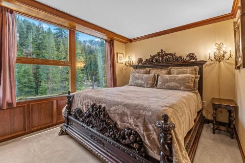 a bedroom with a large bed and a large window at Everline Resort & Spa 701 & 703 in Olympic Valley