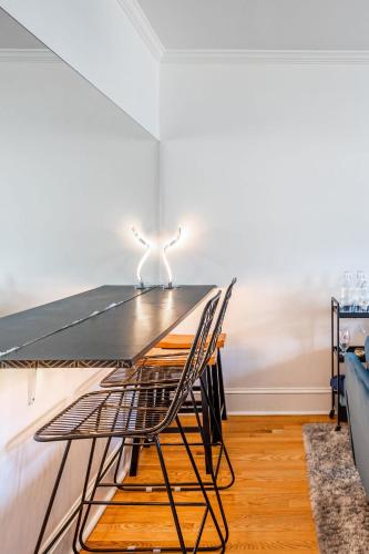 a dining room with a table and a chair at The B&W Haven 5BR Home with yard theater in Bridgeport