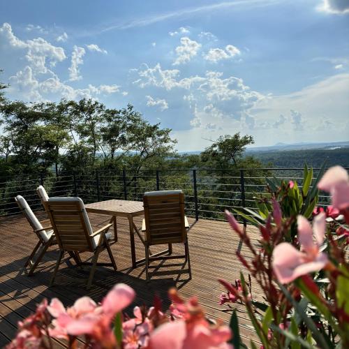 two chairs and a table on a deck with a view at La Vida Panorama in Batina