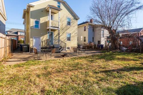 a house with a yard with chairs in front of it at The B&W Haven 5BR Home with yard theater in Bridgeport