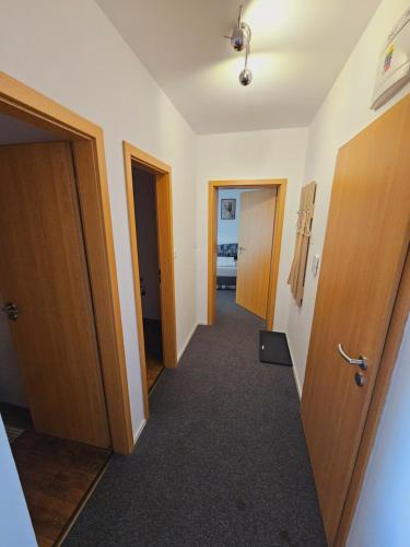 an empty hallway with two doors and a room with a hallway at Apartmány Summit in Bešeňová