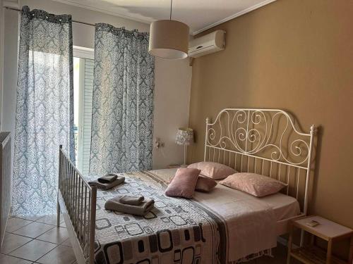 a bedroom with a bed with shoes on it at Luxury City Center Apartment in Kalabaka