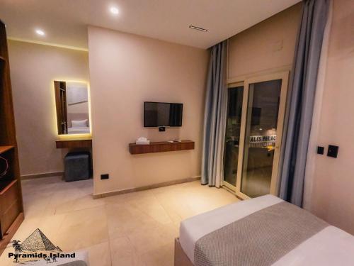 a hotel room with a bed and a television at Pyramids Island in Cairo