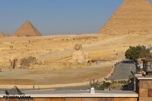 a view of the pyramids of giza from the top of a building at Pyramids Island in Cairo