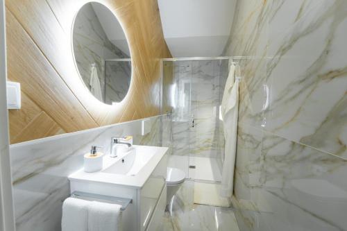 a bathroom with a white sink and a mirror at Ria View Guesthouse in Faro