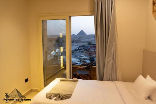 a bedroom with a bed and a window with a view at Pyramids Island in Cairo