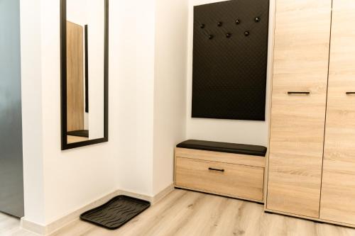 a room with a closet with a black seat at Apartament Akacjowa in Gollnow