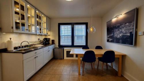 a kitchen with a table and chairs and a sink at The Blue Sapphire 2BR 2 King beds & ample backyard in Bridgeport