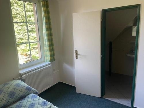 a bedroom with a bed and a window and a door at Patriot penzion a kemp in Držková