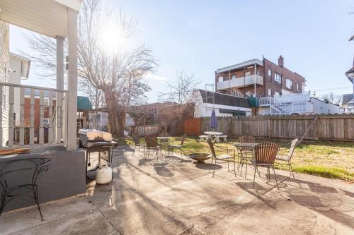 a group of chairs and tables on a patio at The B&W Haven 3BR private office by LI Ferry in Bridgeport
