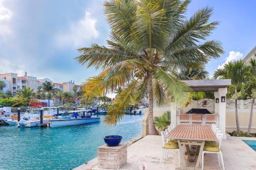 a palm tree sitting next to a body of water at Abundance and Prosperity Villa in Long Bay Hills