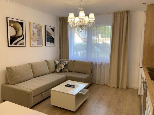 a living room with a couch and a table at Apartment Naturjuwel in Hünxe