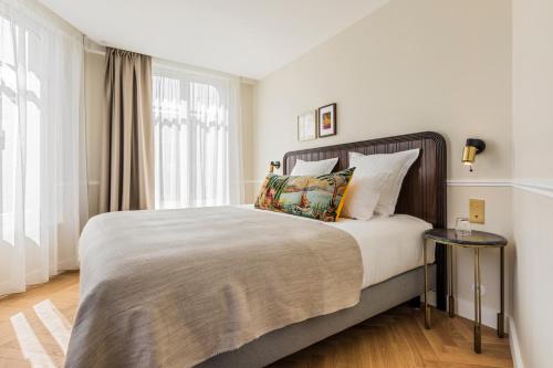 a bedroom with a large bed and a window at Hôtel Chamar in Paris
