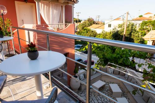 a balcony with a white table and some plants at Cristina Apartments in Gaios