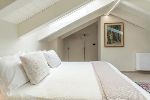 a bedroom with a large white bed with pillows at Luxury 2BR w/ River Castle View in Borgo Valsugana in Borgo