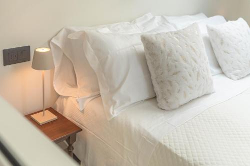 a white bed with white sheets and pillows at Luxury 2BR w/ River Castle View in Borgo Valsugana in Borgo