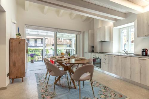 a kitchen and dining room with a table and chairs at Luxury 2BR w/ River Castle View in Borgo Valsugana in Borgo