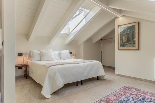a bedroom with a large bed and a skylight at Luxury 2BR w/ River Castle View in Borgo Valsugana in Borgo