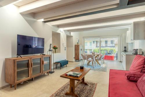 a living room with a couch and a tv and a table at Luxury 2BR w/ River Castle View in Borgo Valsugana in Borgo