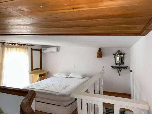 a bedroom with a bed and a wooden ceiling at Casa Piaduli in Faliraki