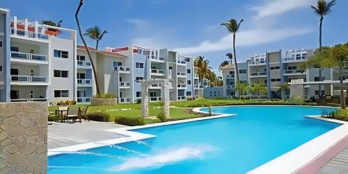 an image of the exterior of a resort with a swimming pool at Duplex,near the Beach plus airport in Punta Cana