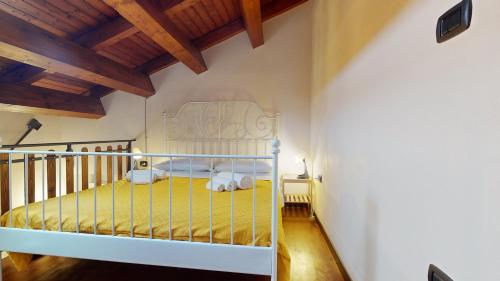 a bedroom with a bed in a room with wooden ceilings at Casal Trinacria in Santa Teresa di Riva