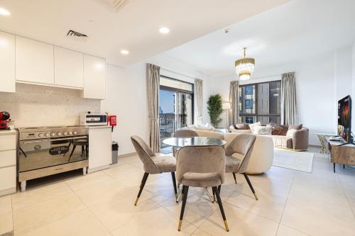 a kitchen and living room with a table and chairs at Spectacular 2BR Apartment Full BurjAlArab View in Dubai