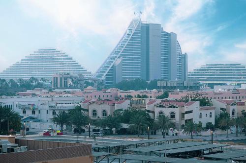 a city with many tall buildings and palm trees at Spectacular 2BR Apartment Full BurjAlArab View in Dubai
