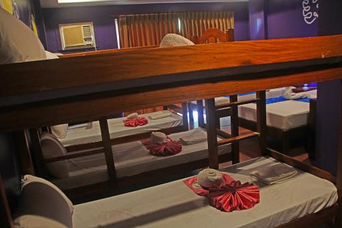 a group of beds in a room at Hotel Palacio Puerto Princesa in Puerto Princesa City