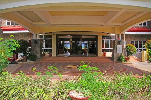 a building with a spiral design in front of it at Hotel Palacio Puerto Princesa in Puerto Princesa City