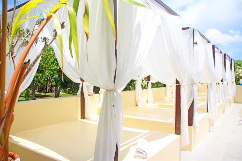 a row of white umbrellas on a balcony at Hotel Palacio Puerto Princesa in Puerto Princesa City