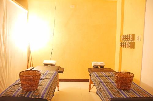 a room with two beds with baskets on them at Hotel Palacio Puerto Princesa in Puerto Princesa City