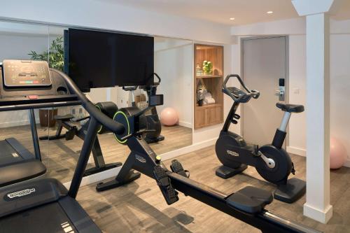 a living room with a gym with two exercise bikes at Best Western Plus La Demeure in Paris