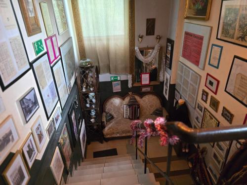 a hallway with a staircase with pictures on the walls at Apartament Wilhelma II in Ząbkowice Śląskie