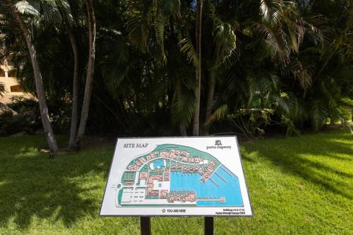 a sign in the grass in front of a resort at Designers Delight 3 BR w Pool Gym Tennis Courts in Cupecoy