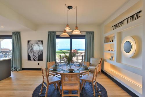 a dining room with a table and chairs at Designers Delight 3 BR w Pool Gym Tennis Courts in Cupecoy