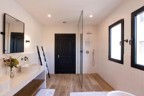 a bathroom with a sink and a shower at Designers Delight 3 BR w Pool Gym Tennis Courts in Cupecoy
