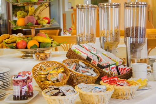 a table with baskets of food and fruit on it at Hotel Spongiola in Krapanj
