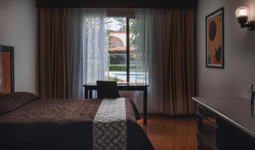 Ένα ή περισσότερα κρεβάτια σε δωμάτιο στο Hotel & Suites Villa del Sol