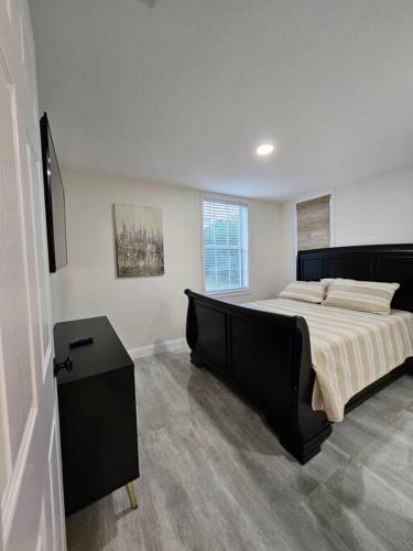 a bedroom with a large bed and a table at Cozy Two Bedrooms Apartment in Valrico in Valrico